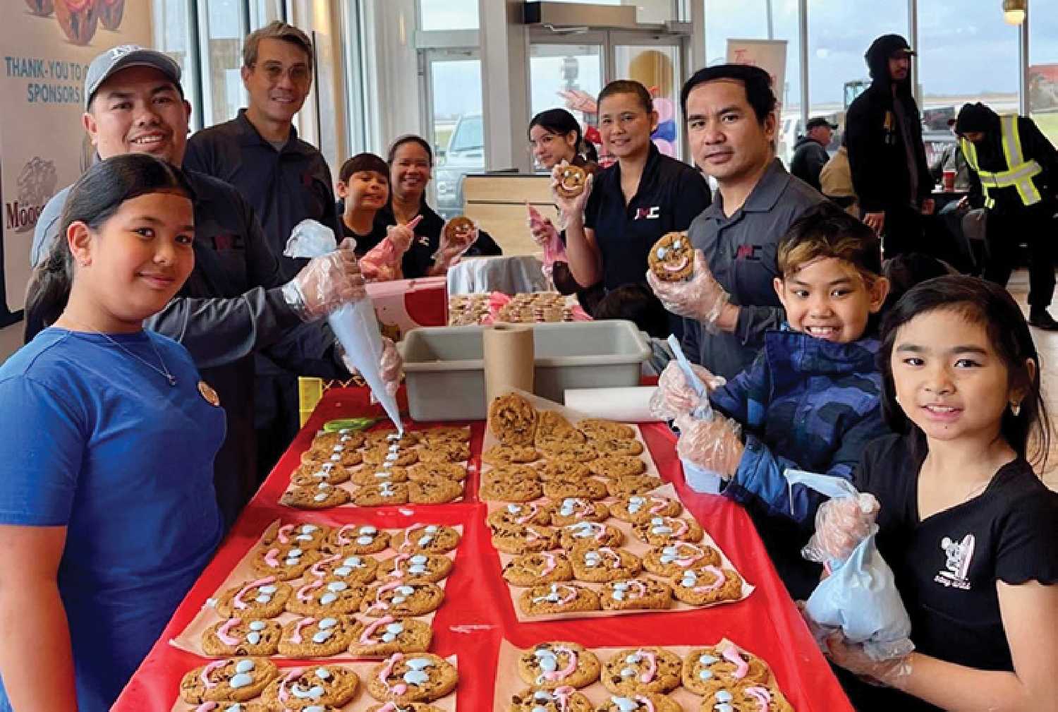 JMC Cleaning Services staff and families decorate cookies during Smile Cookie Week in Moosomin.
